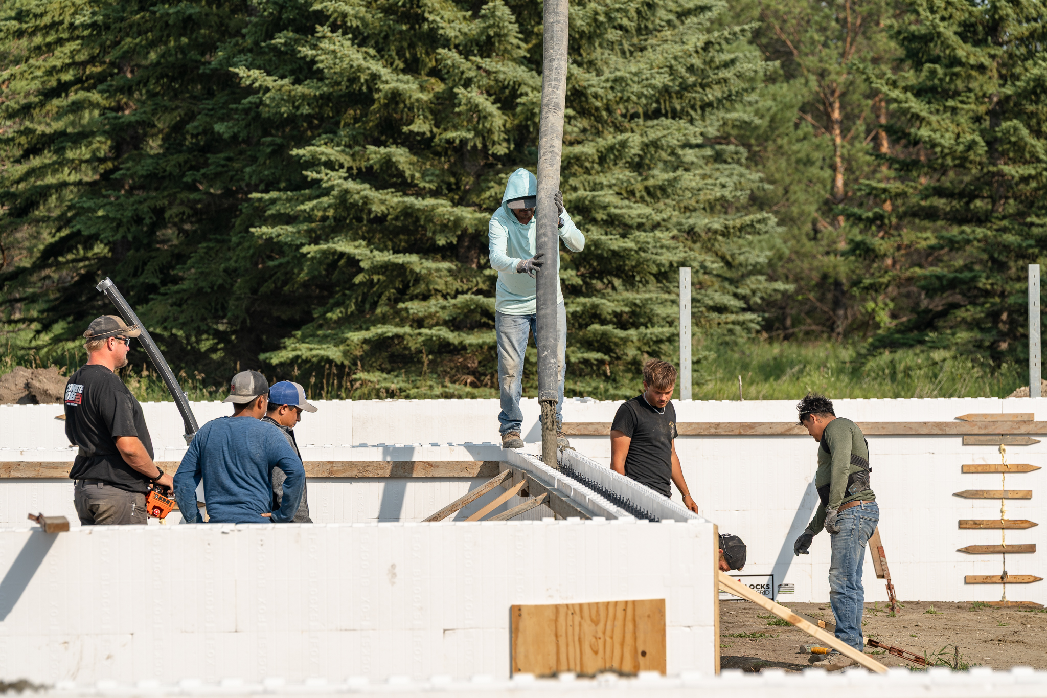 Five-man crew working ICF walls during pour