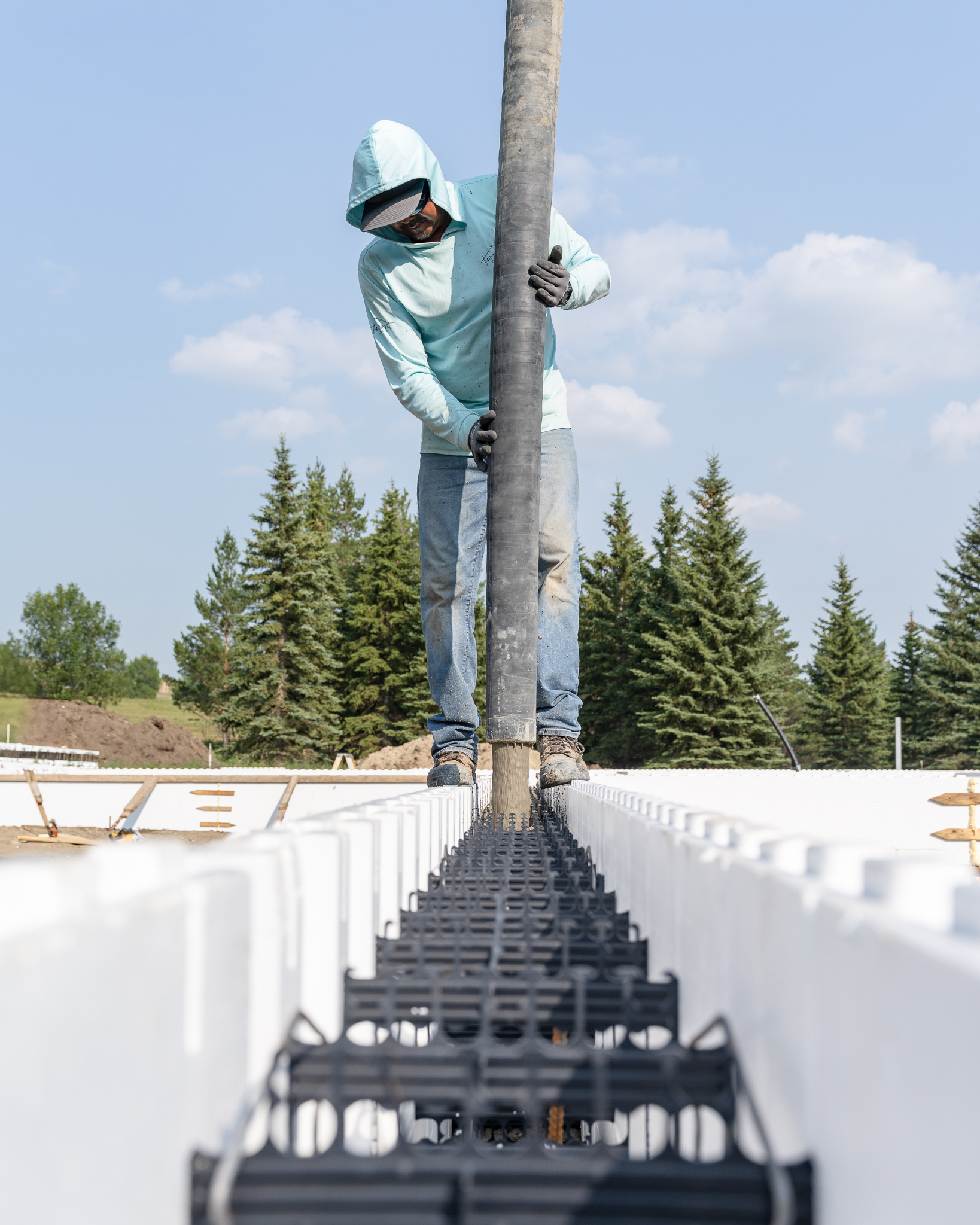 Full crew working alongside pump truck and ICF walls
