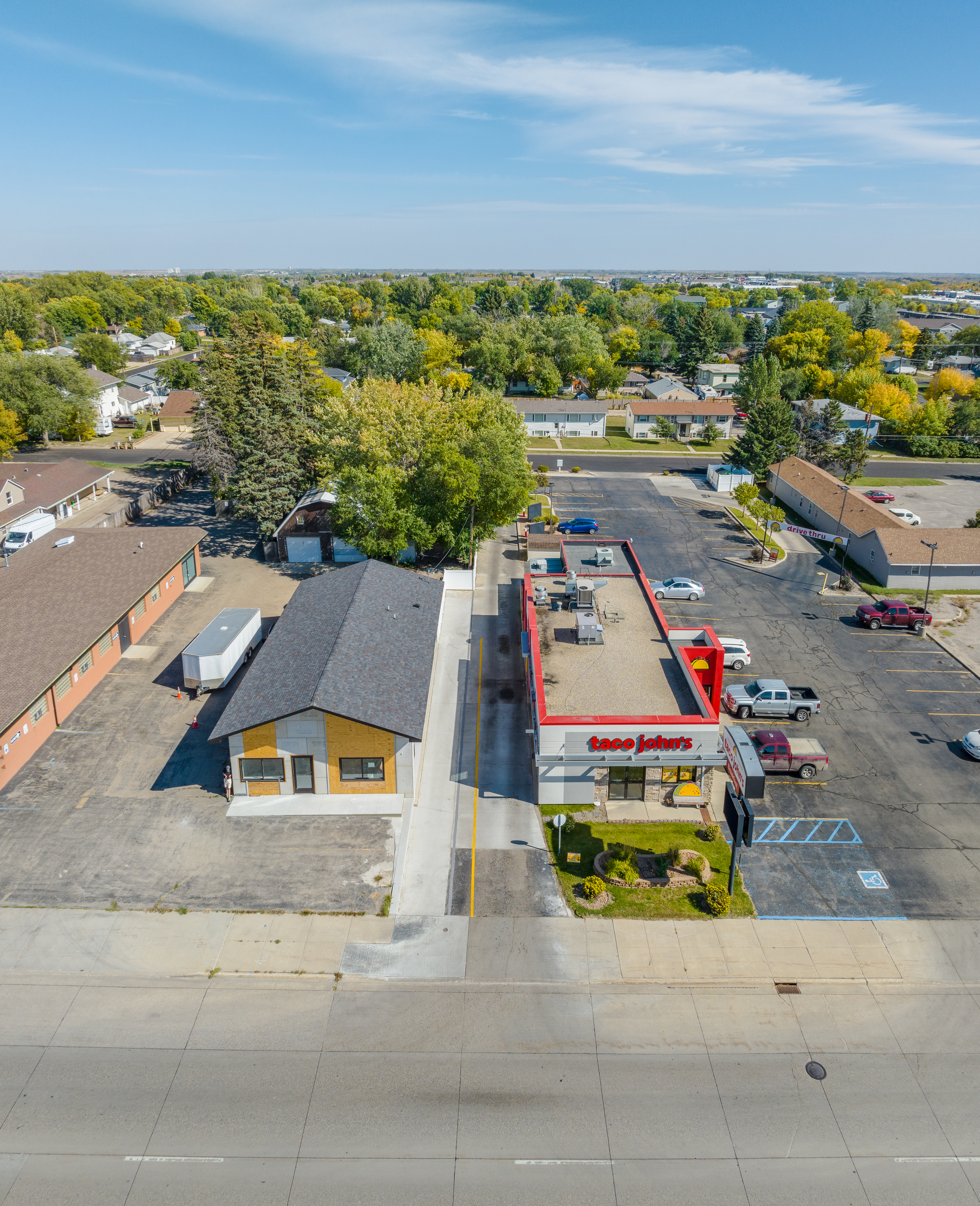 Wide aerial showing full commercial concrete project and parking areas