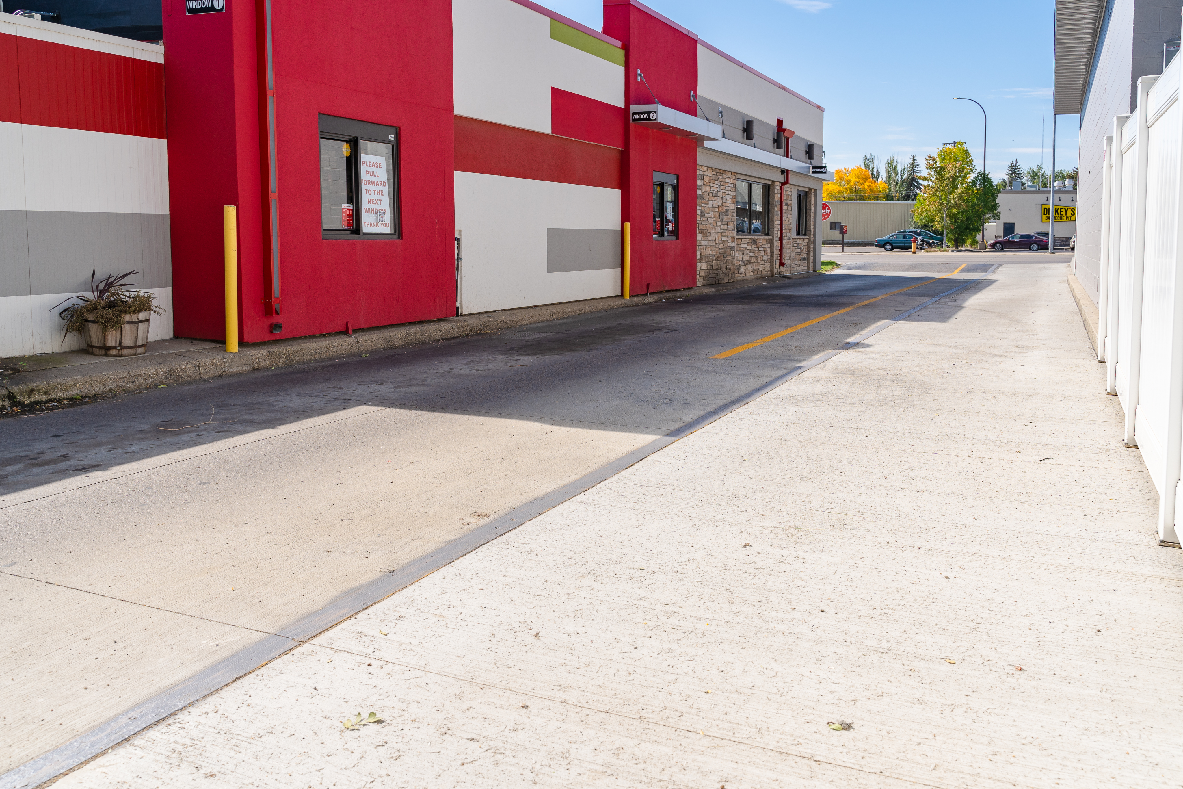 Smooth concrete drive lane with control joints along commercial building