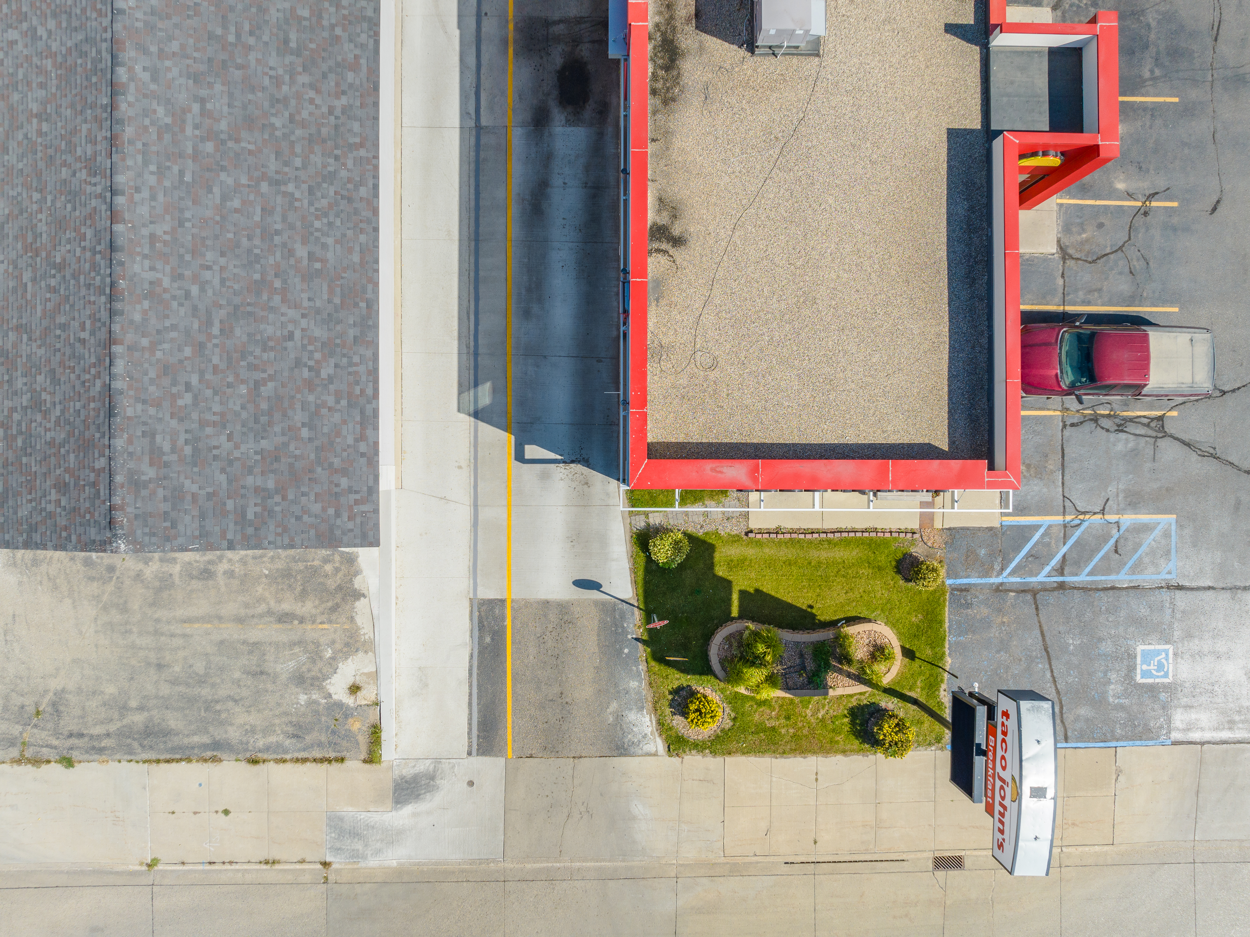 Overhead drone view of commercial concrete drive lane and sidewalks