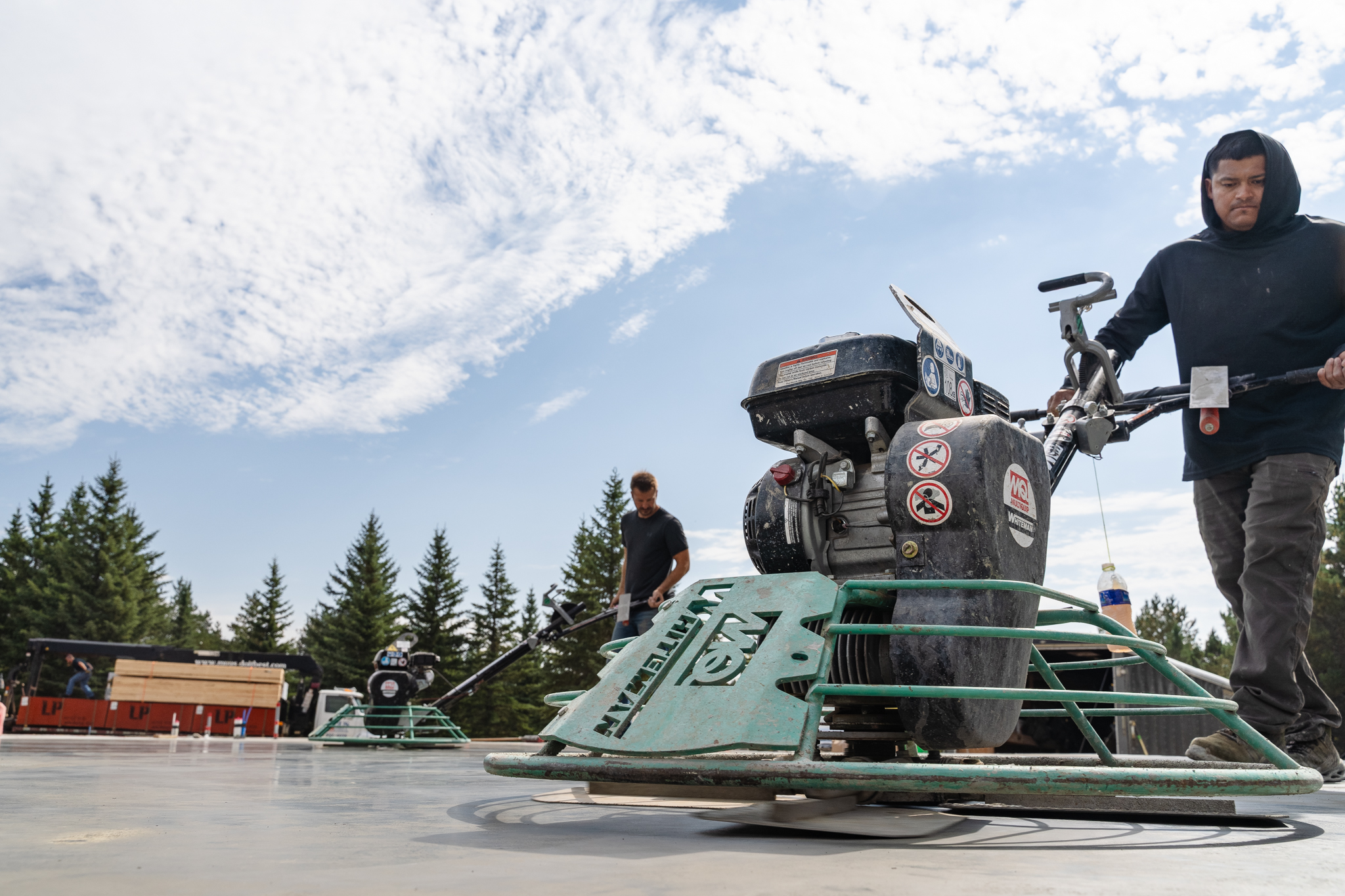 Low-angle dramatic shot of power trowel finishing concrete